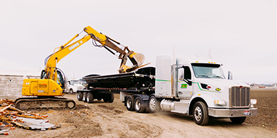 Side dump truck being filled
